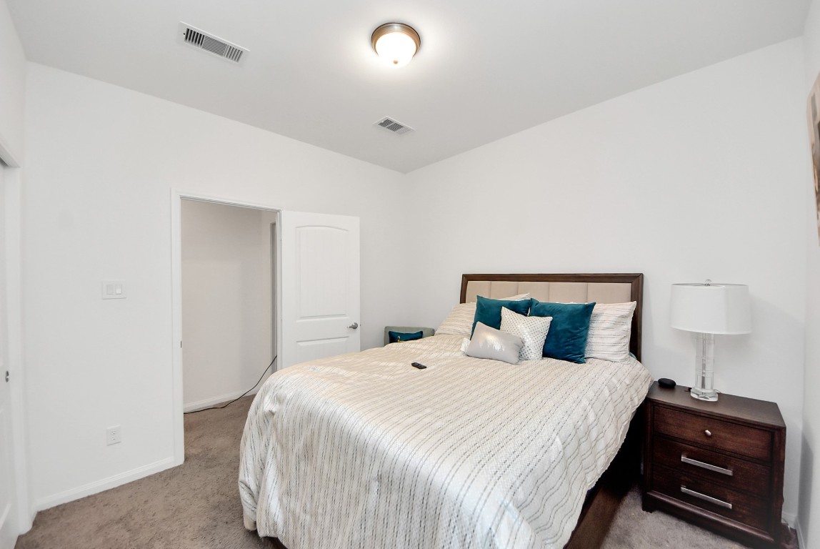 9447 Klein Lane Houston, TX 77044 - Photo 41 of 41 a bedroom with a bed and a lamp