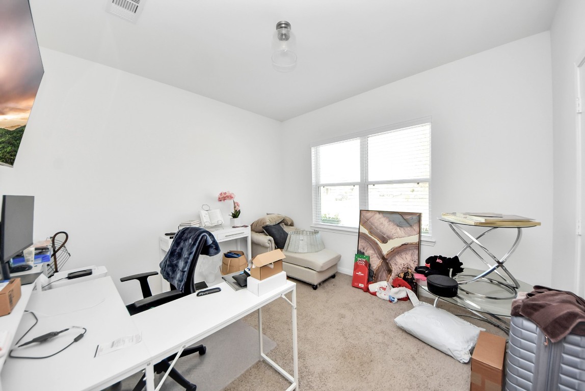 9447 Klein Lane Houston, TX 77044 - Photo 29 of 41 a view of a workspace with furniture and a window