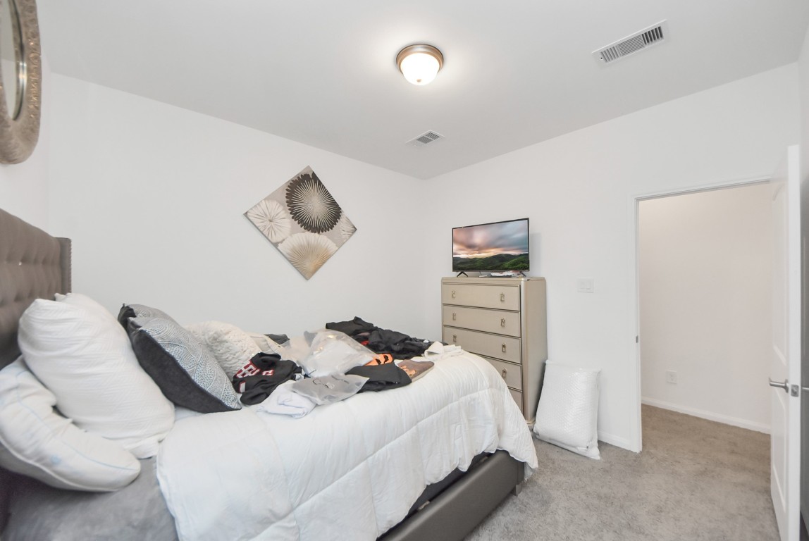 9447 Klein Lane Houston, TX 77044 - Photo 32 of 41 a bedroom with a bed and closet