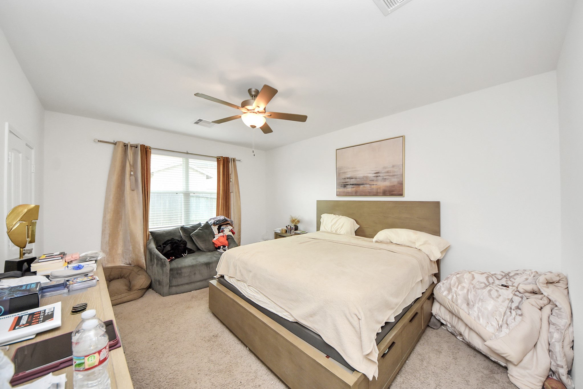 9447 Klein Lane Houston, TX 77044 - Photo 33 of 41 a bedroom with a bed a couch and a window