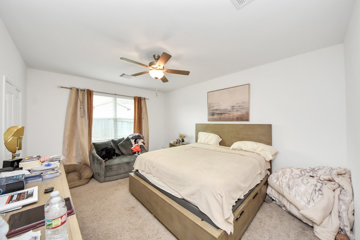 9447 Klein Lane Houston, TX 77044 - Photo 33 of 41 a bedroom with a bed a couch and a window