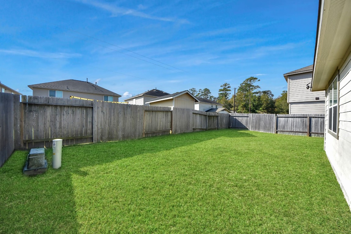 9447 Klein Lane Houston, TX 77044 - Photo 38 of 41 a view of a backyard with table and chairs and wooden fence