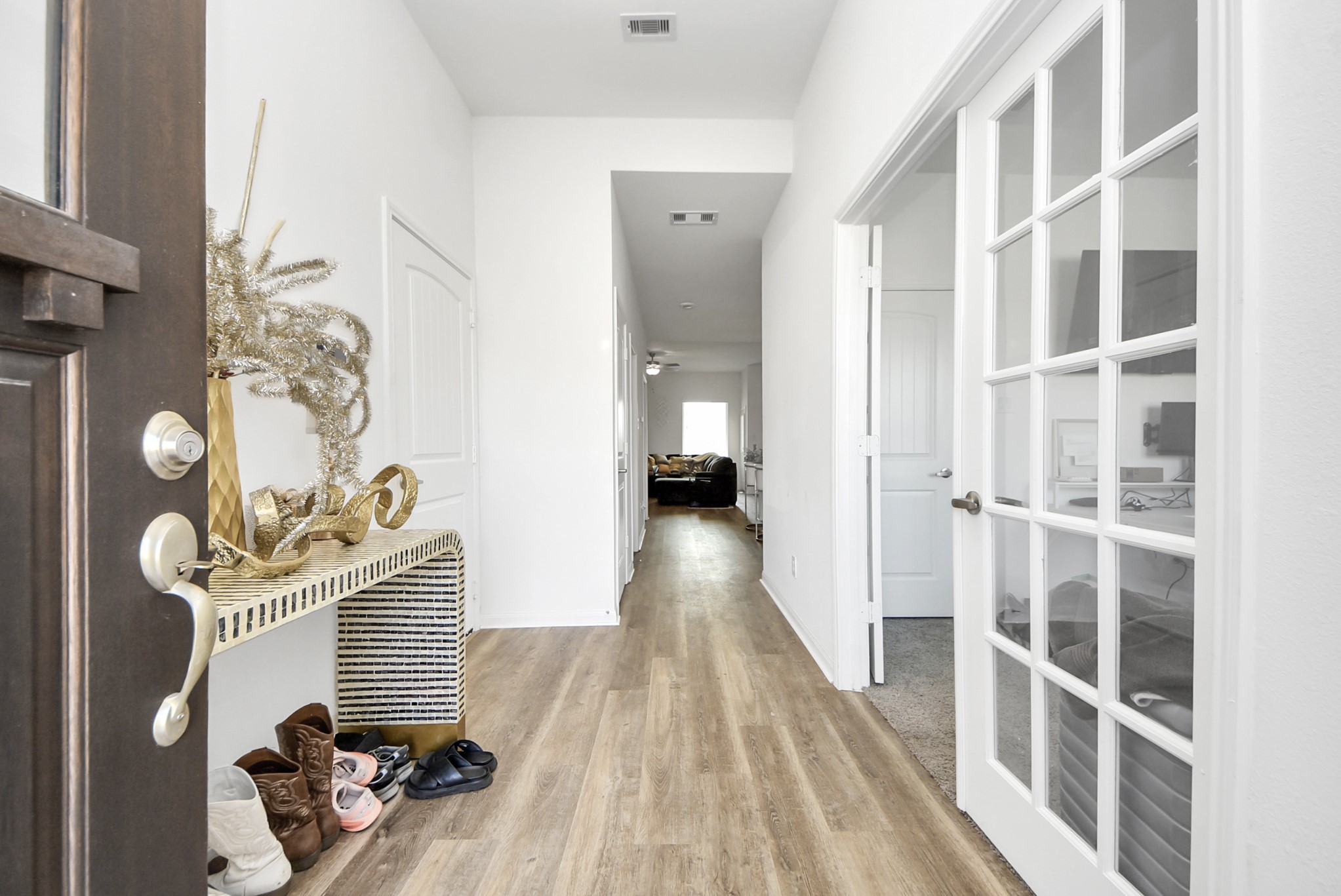 9447 Klein Lane Houston, TX 77044 - Photo 8 of 41 a view of a hallway with wooden floor and a dining room