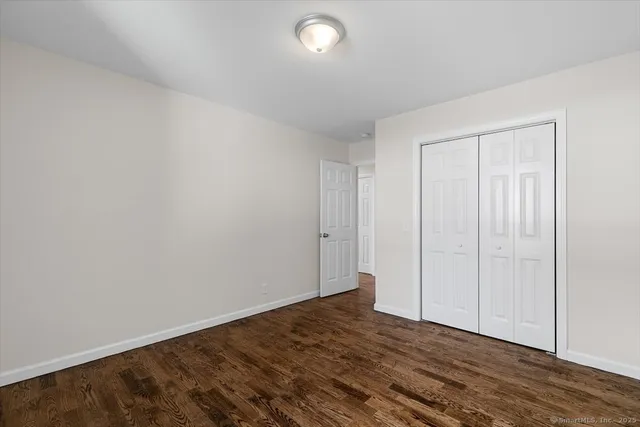 a view of an empty room and wooden floor