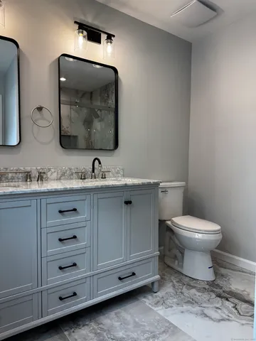 a bathroom with a double vanity sink and a mirror