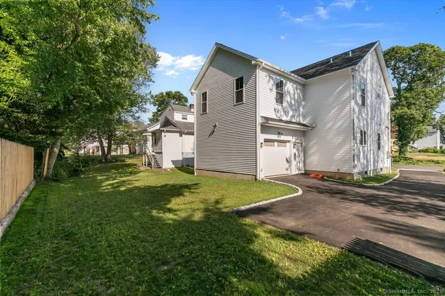 a view of a backyard with large trees