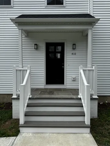 a front view of a house with entryway and windows