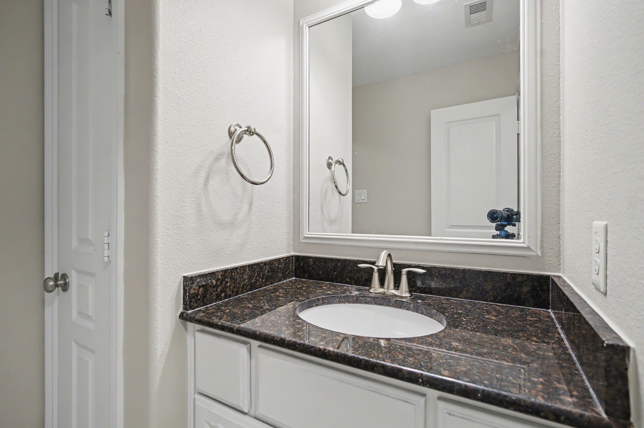 5205 Larkin Street Houston, TX 77007 - Photo 29 of 38 a bathroom with a granite countertop sink and a mirror