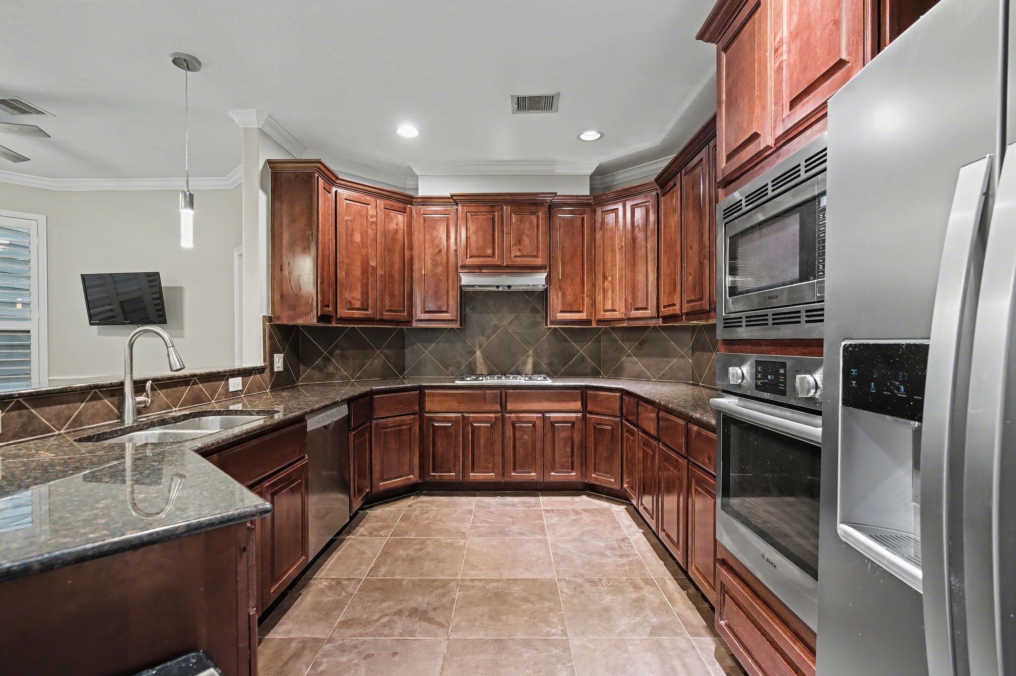 5205 Larkin Street Houston, TX 77007 - Photo 4 of 38 a kitchen with stainless steel appliances granite countertop a sink stove microwave and refrigerator