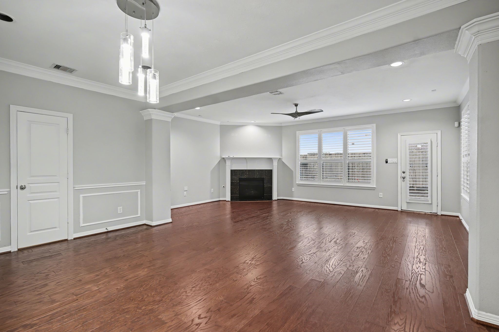 5205 Larkin Street Houston, TX 77007 - Photo 7 of 38 a view of empty room with wooden floor fireplace and window