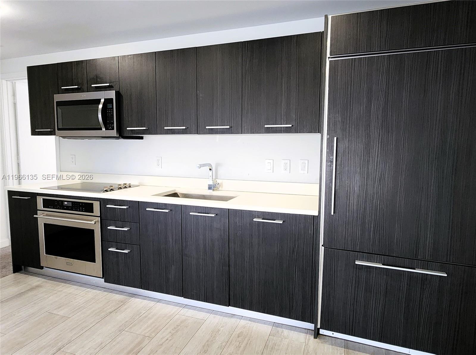 45 Southwest 9th Street, Unit 2108 Miami, FL 33130 - Photo 24 of 55 a kitchen with a sink and a microwave