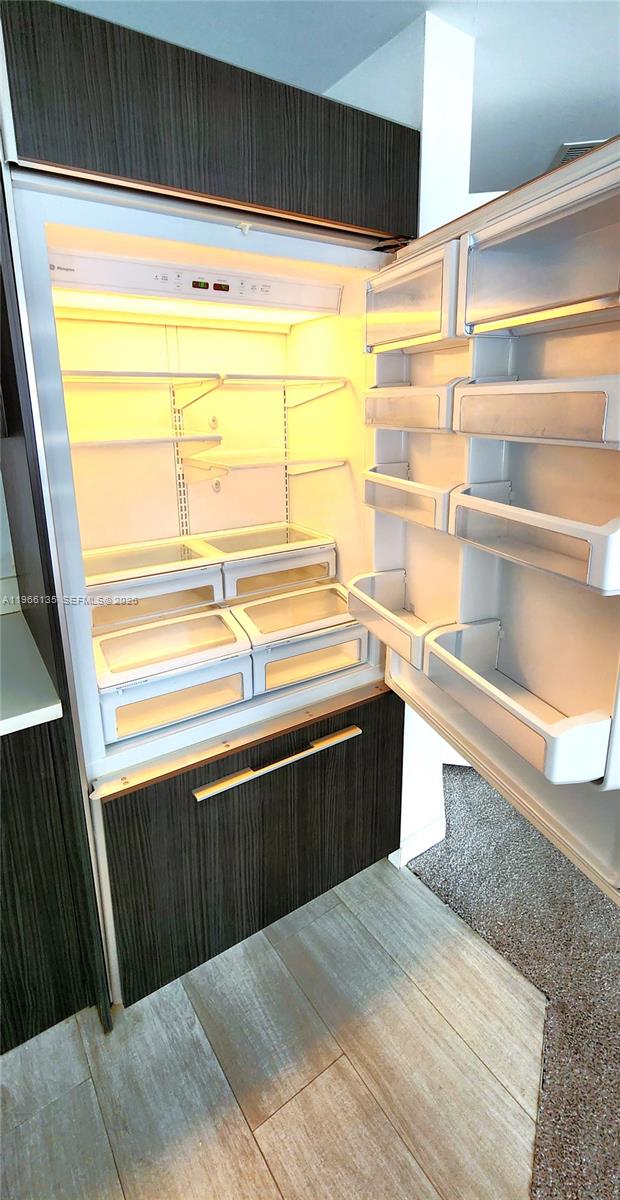 45 Southwest 9th Street, Unit 2108 Miami, FL 33130 - Photo 26 of 55 a view of kitchen with granite countertop and white cabinets