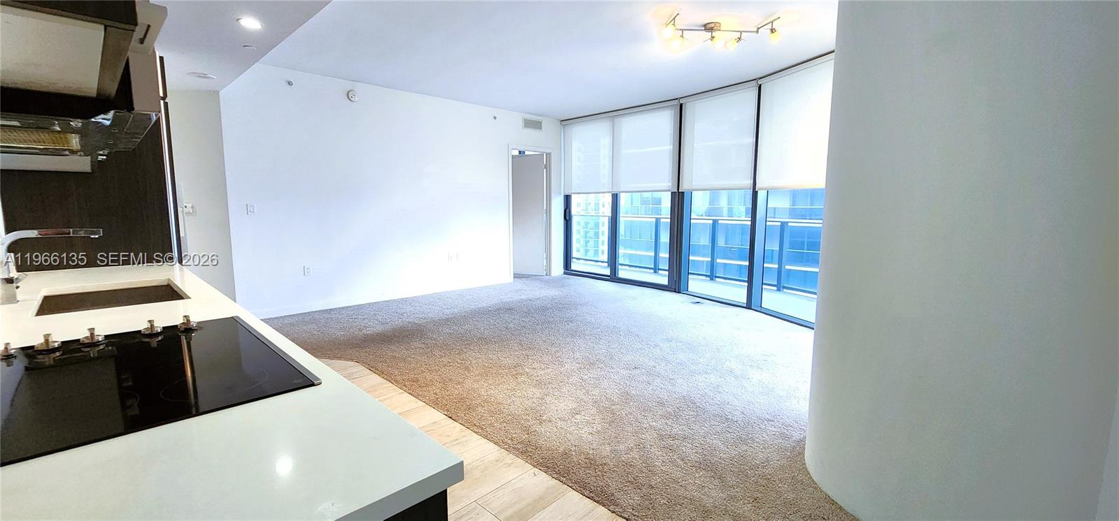 45 Southwest 9th Street, Unit 2108 Miami, FL 33130 - Photo 27 of 55 a view of a kitchen with stainless steel appliances wooden floor and a window