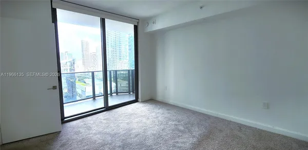 a view of empty room with floor to ceiling window
