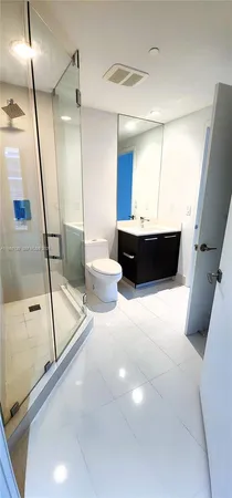 a view of a livingroom with workspace and a large window