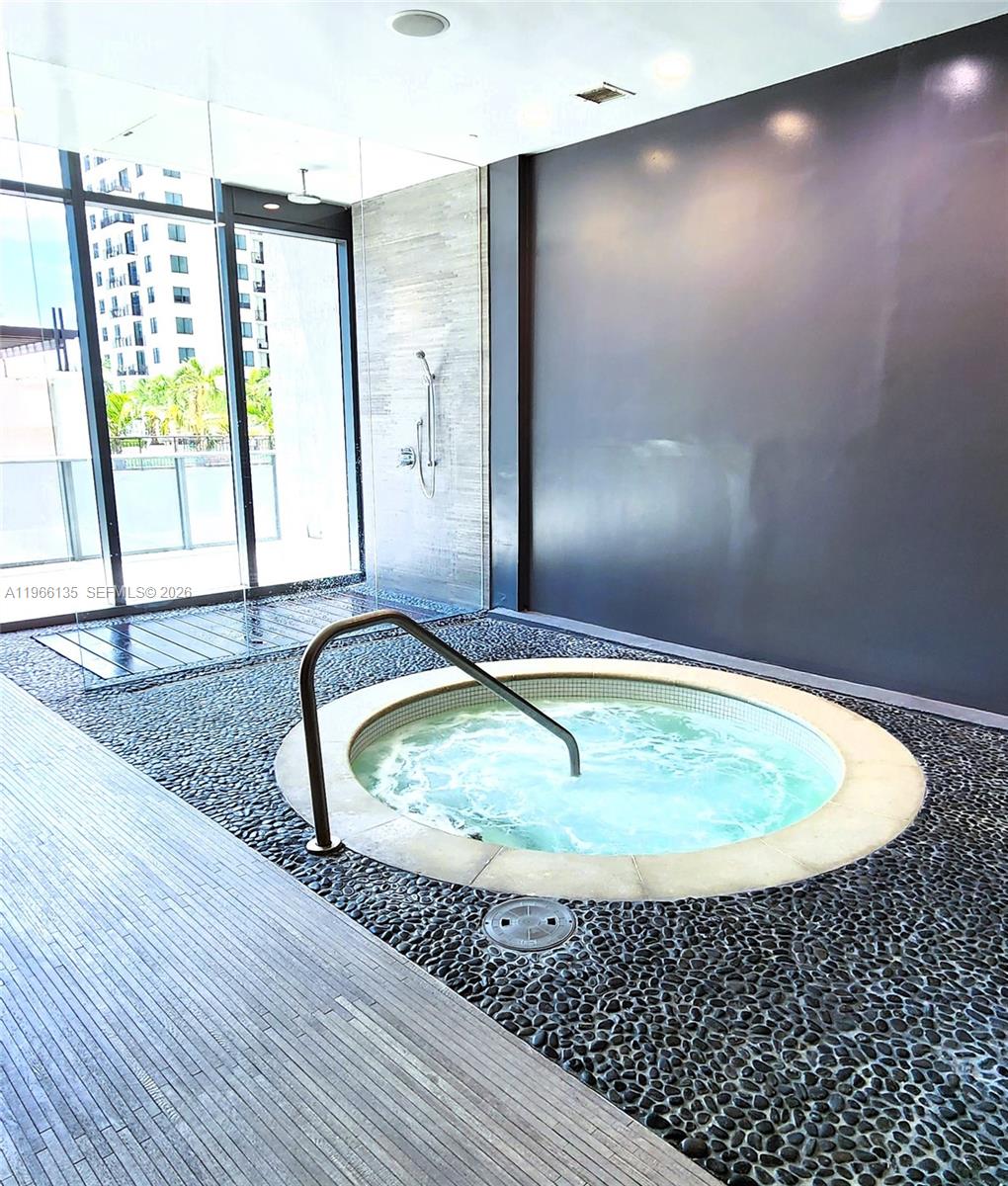 45 Southwest 9th Street, Unit 2108 Miami, FL 33130 - Photo 44 of 55 a bathroom with a granite countertop sink and a mirror