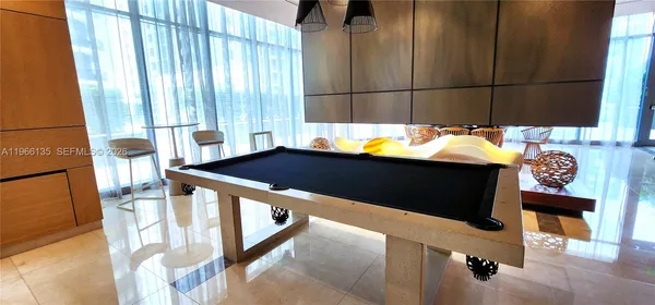 a view of tall building with large windows and plants