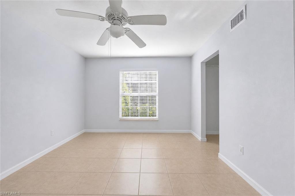 5737 Whitaker Road, Unit C101 Naples, FL 34112 - Photo 18 of 28 a view of an empty room with a window