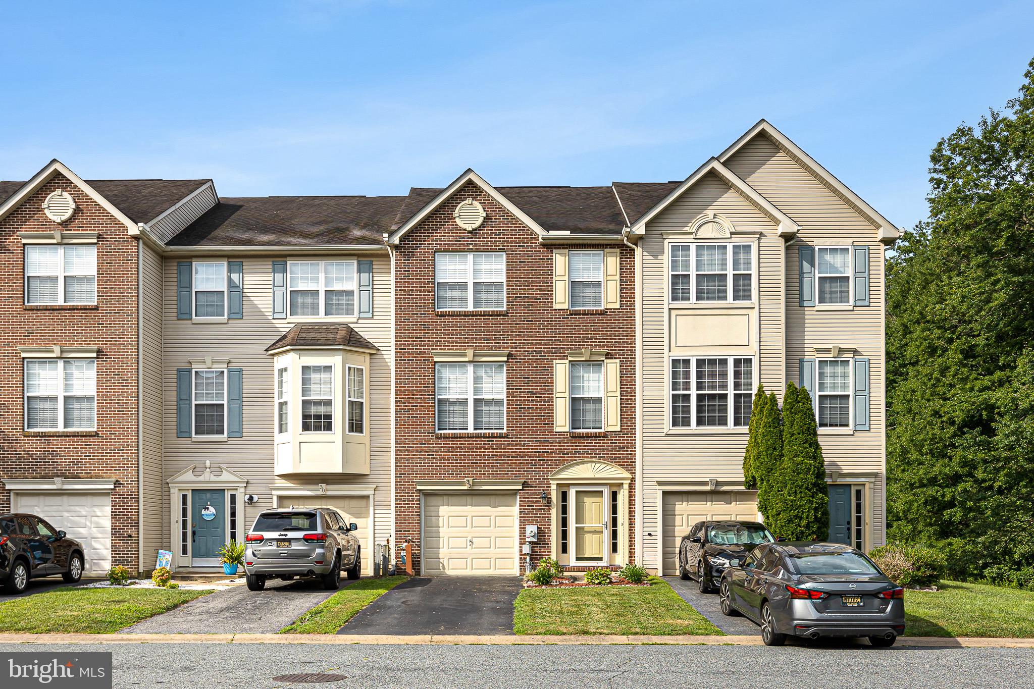a front view of a residential apartment building with a yard