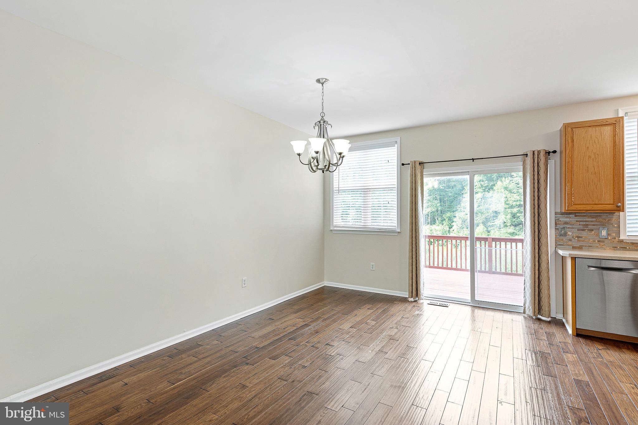 32 Ballina Boulevard Bear, DE 19701 - Photo 8 of 25 wooden floor in an empty room with a window