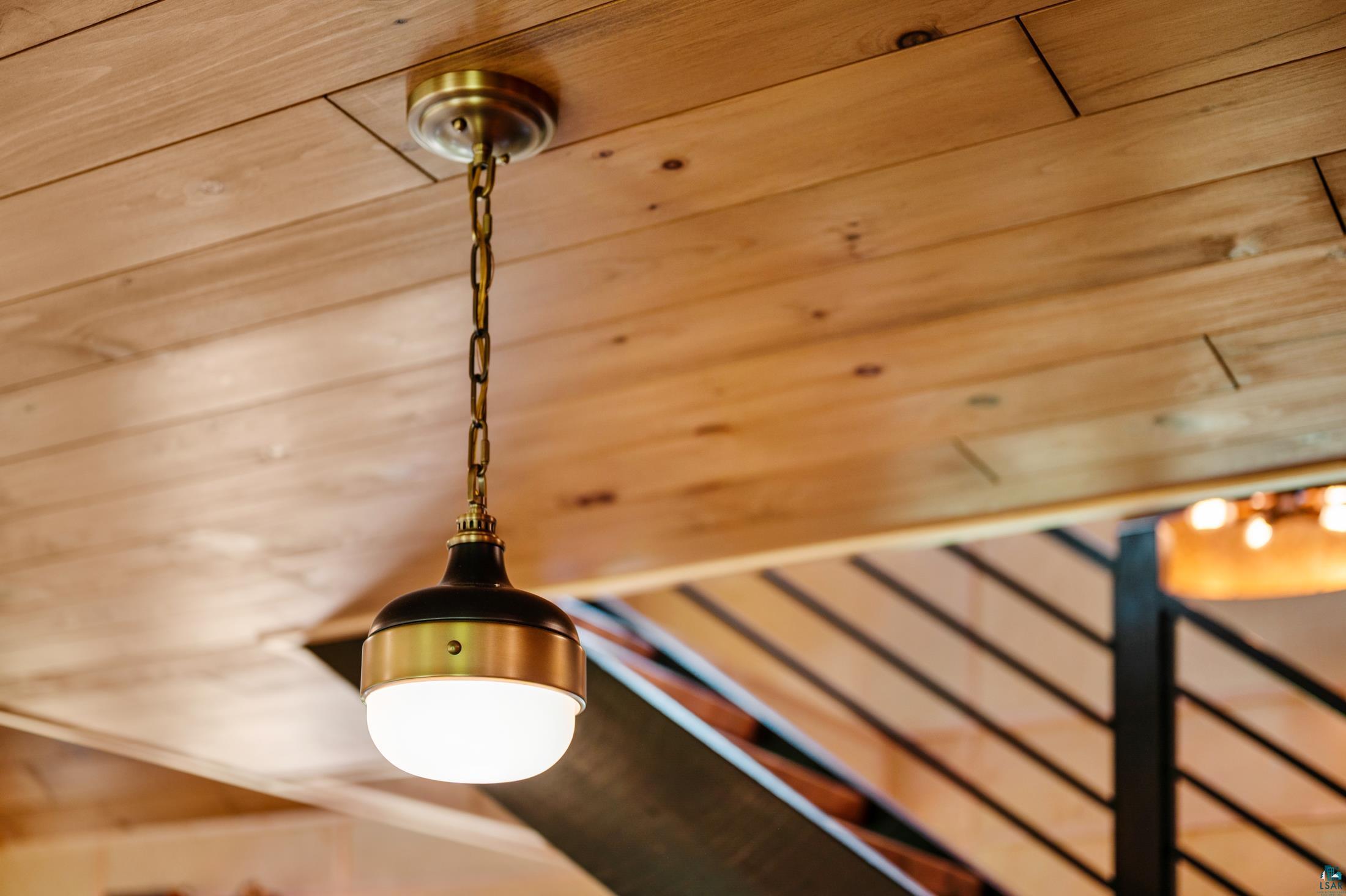 3778 East County Road Barnum, MN 55707 - Photo 18 of 52 Wood plank ceiling with a brass chain pendant light featuring a black and brass fixture and an opaque glass globe