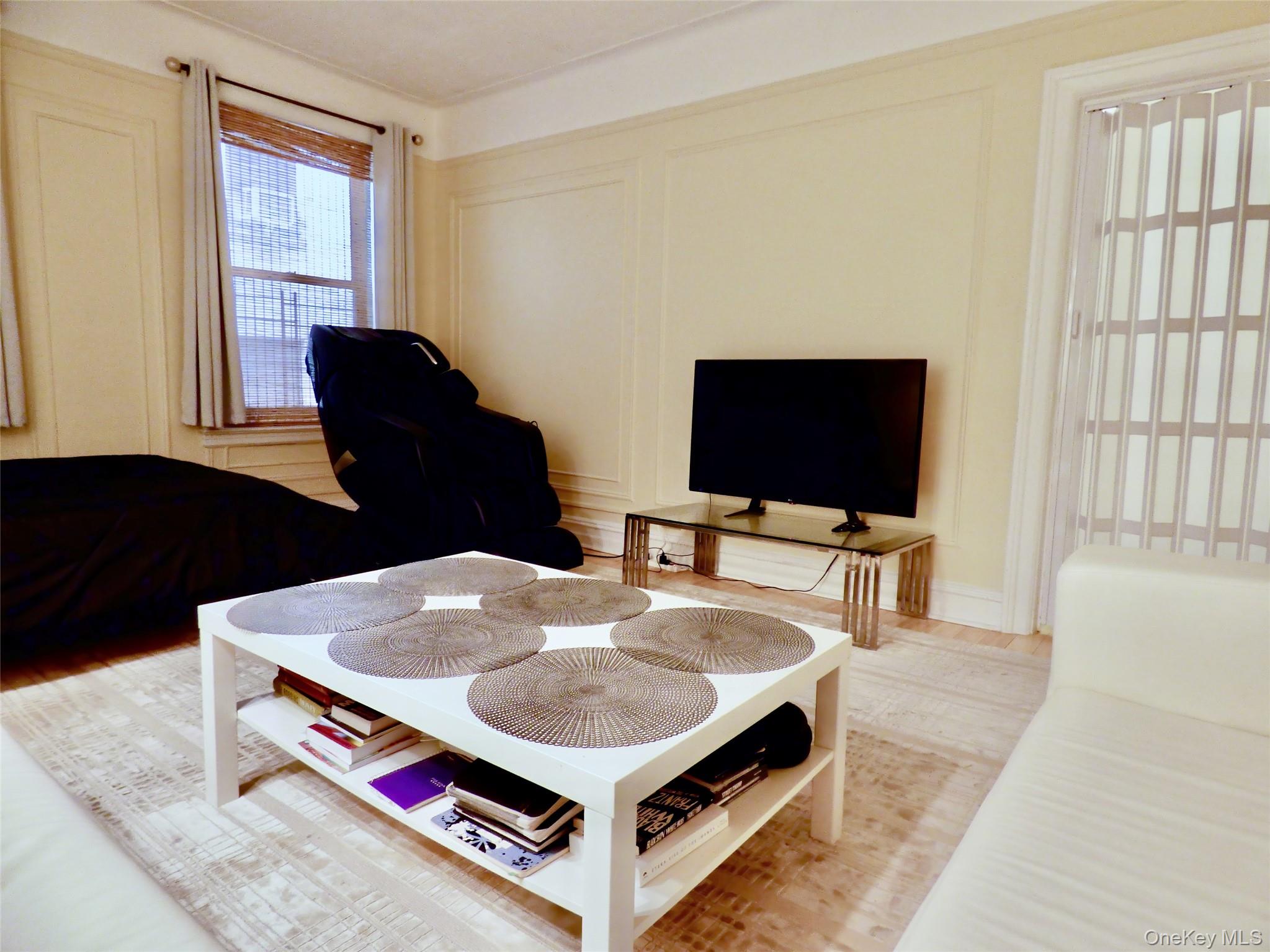 941 Jerome Avenue, Unit D5 Bronx, NY 10452 - Photo 1 of 35 a living room with furniture and a flat screen tv