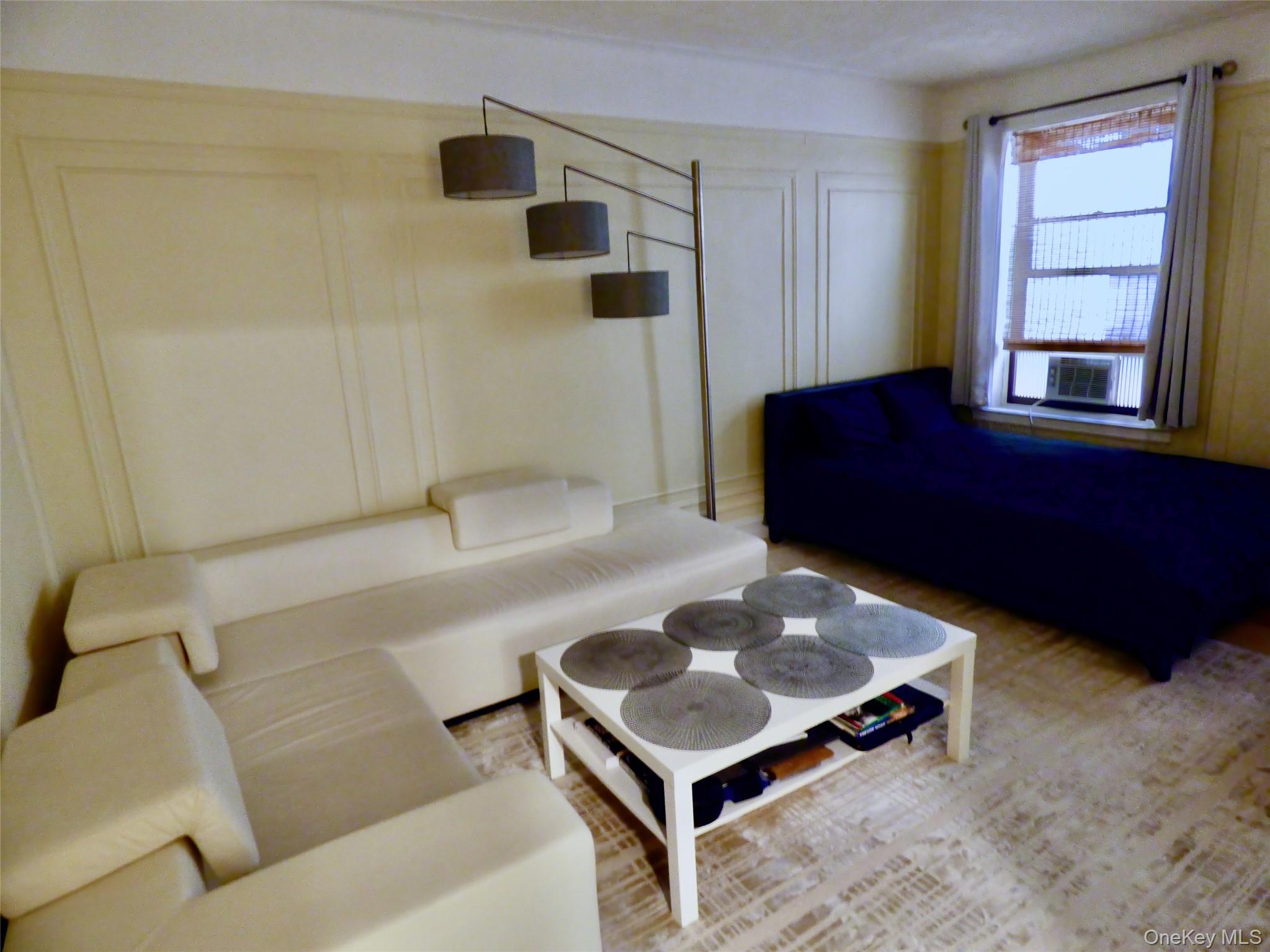 941 Jerome Avenue, Unit D5 Bronx, NY 10452 - Photo 15 of 35 a living room with a couch and a window