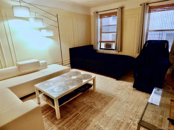 a living room with a bed furniture and a window