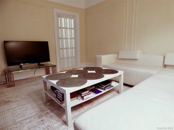 a living room with a flat screen tv and a couch