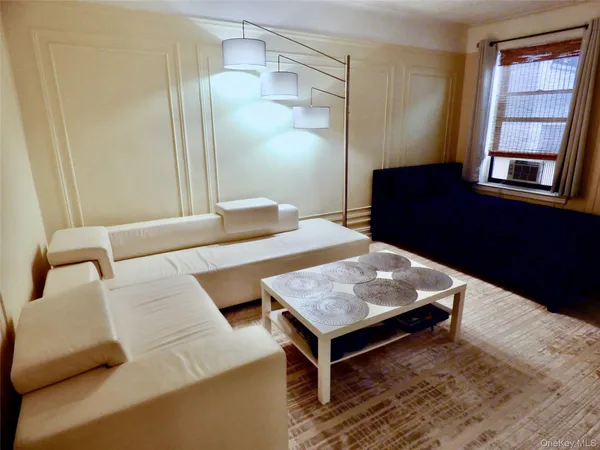 a living room with a table and a window