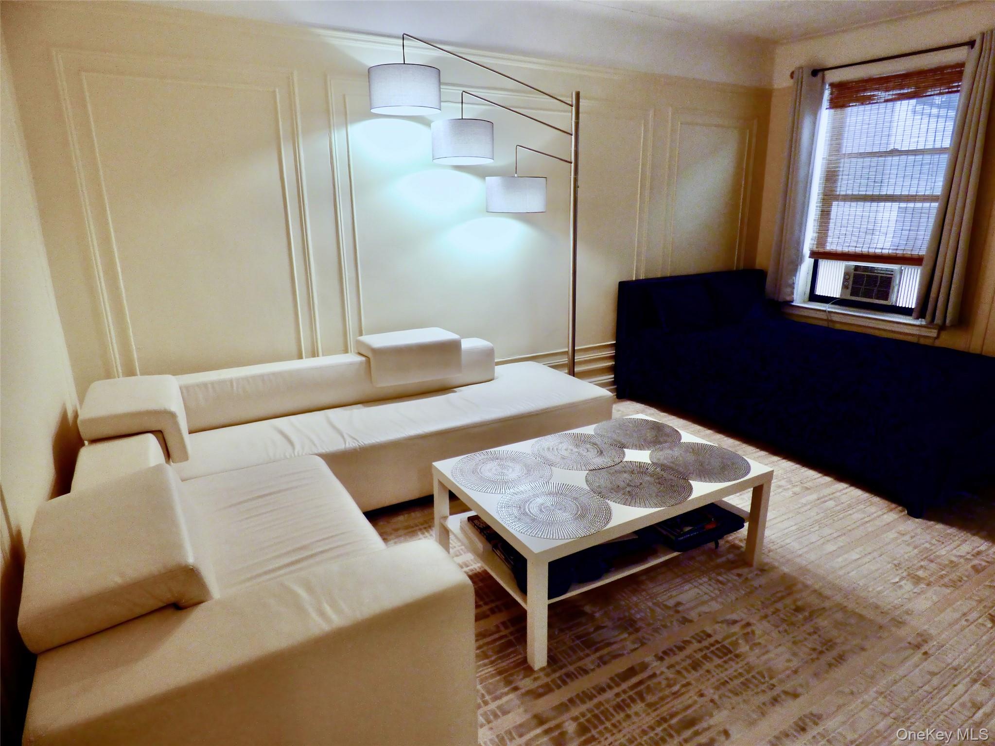 941 Jerome Avenue, Unit D5 Bronx, NY 10452 - Photo 21 of 35 a living room with a table and a window