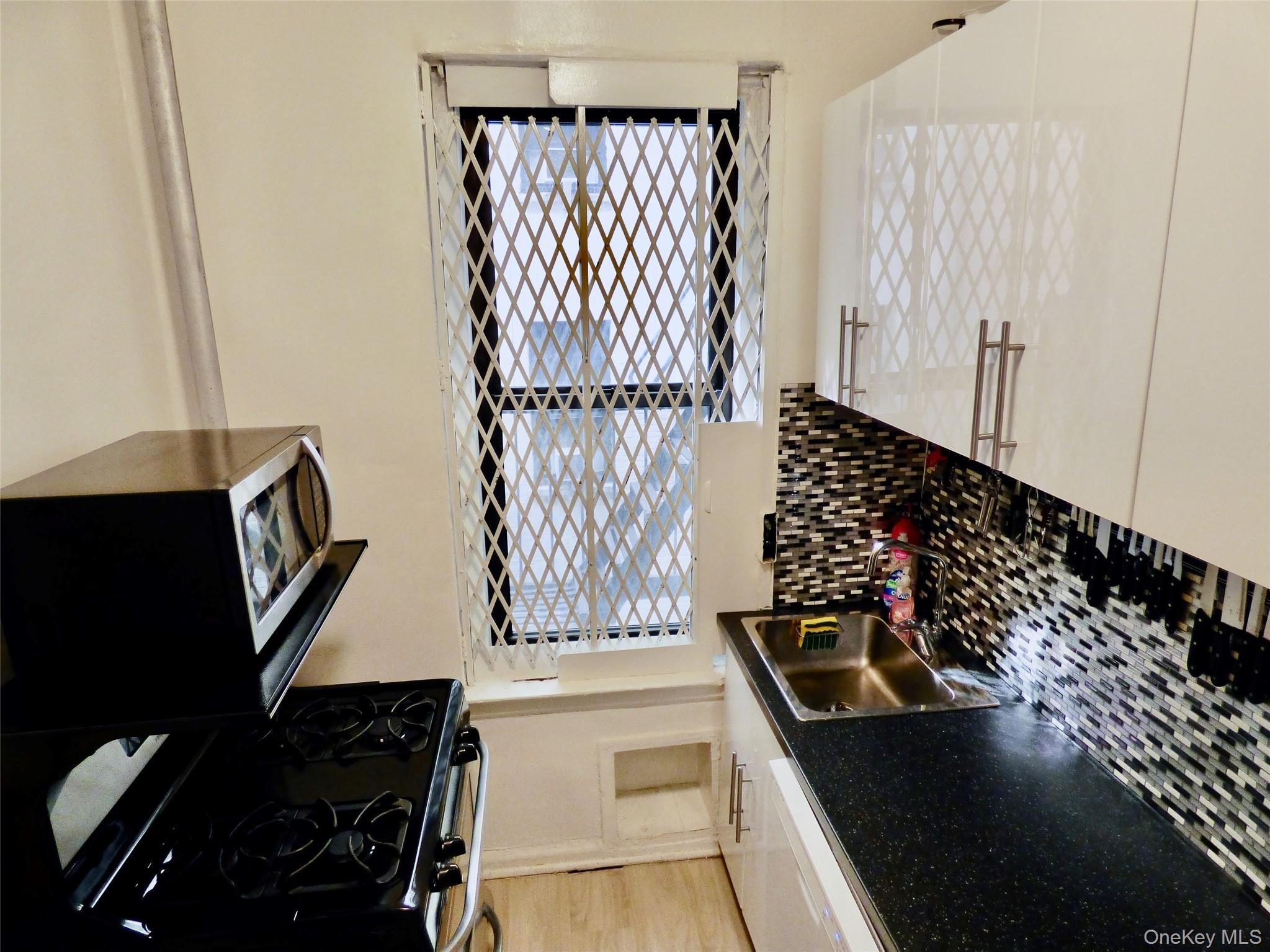 941 Jerome Avenue, Unit D5 Bronx, NY 10452 - Photo 23 of 35 a kitchen with a sink a stove and a refrigerator