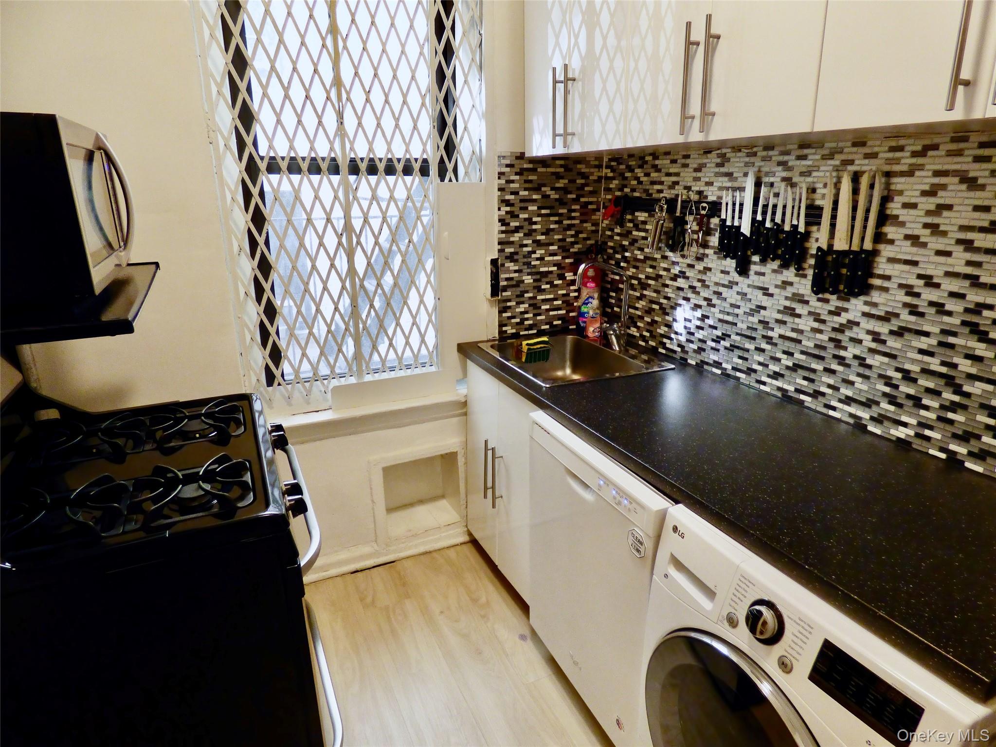 941 Jerome Avenue, Unit D5 Bronx, NY 10452 - Photo 26 of 35 a kitchen with a sink and cabinets