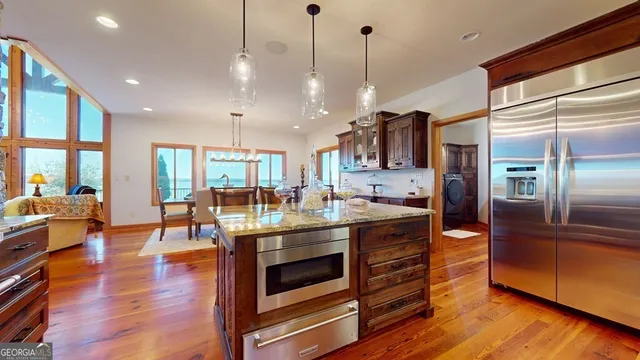 a kitchen with stainless steel appliances granite countertop a stove and refrigerator