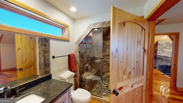 a bathroom with a toilet a sink and shower