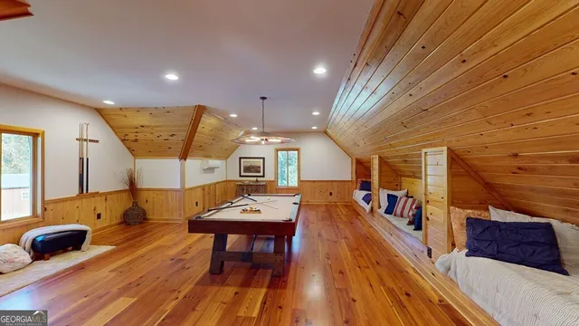 a living room with furniture a wooden floor and next to a window
