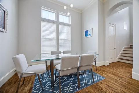 a dining room with furniture a rug and wooden floor