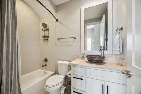 a bathroom with a sink toilet vanity and tub