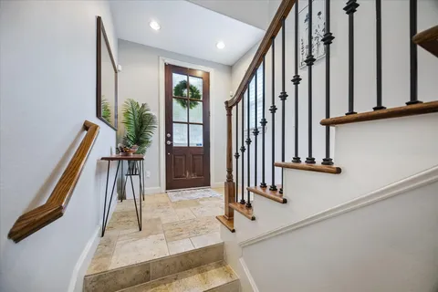 a view of staircase with white walls and railing