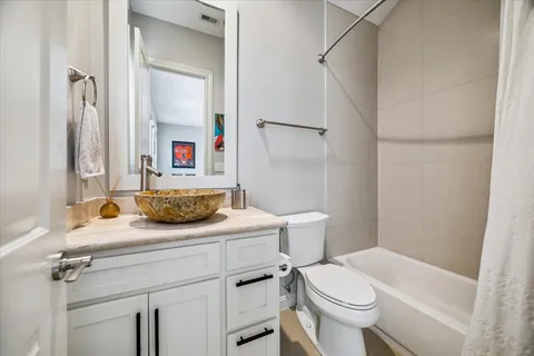 a bathroom with a sink toilet vanity and shower