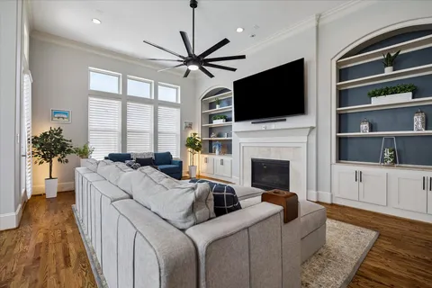 a living room with furniture fireplace and flat screen tv
