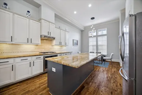 a kitchen with stainless steel appliances granite countertop a sink stove and refrigerator