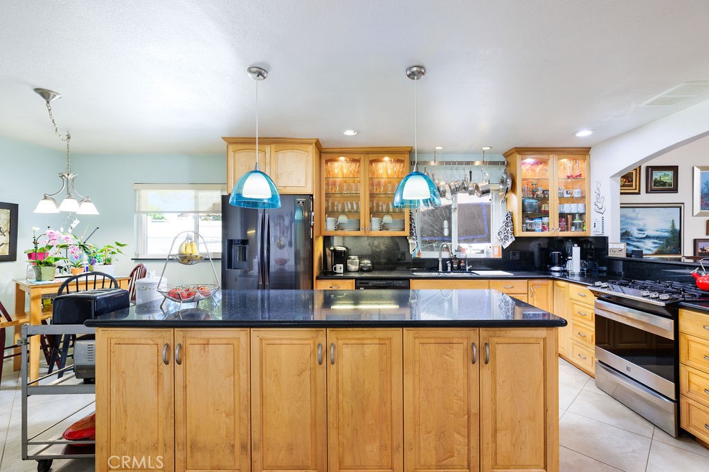 a kitchen with stainless steel appliances granite countertop a stove and more cabinets