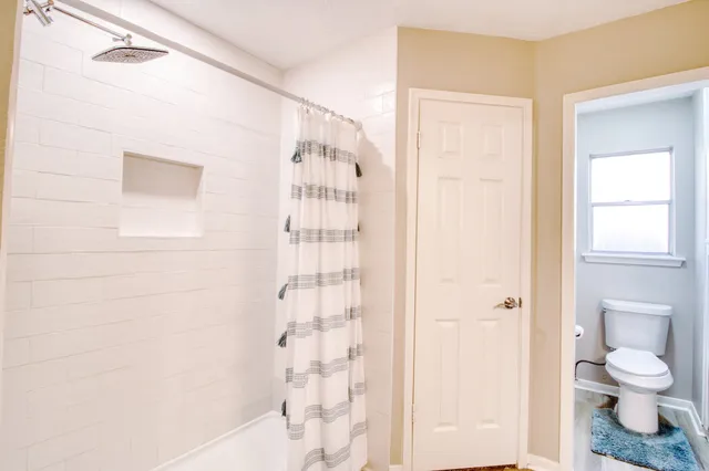 a bathroom with a granite countertop sink a light fixture and a mirror
