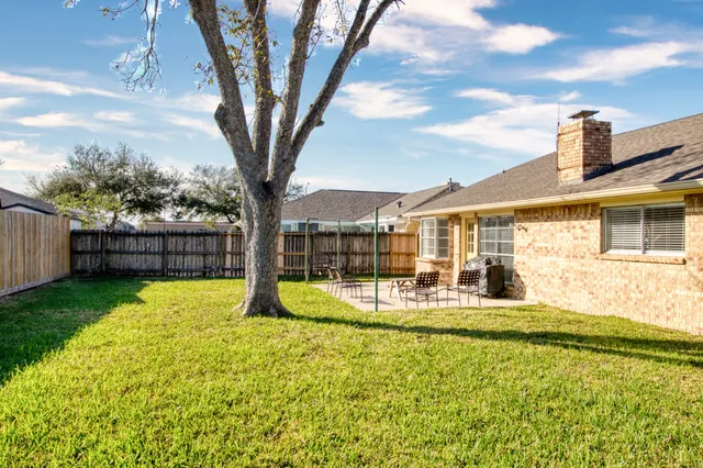 a house view with swimming pool and garden