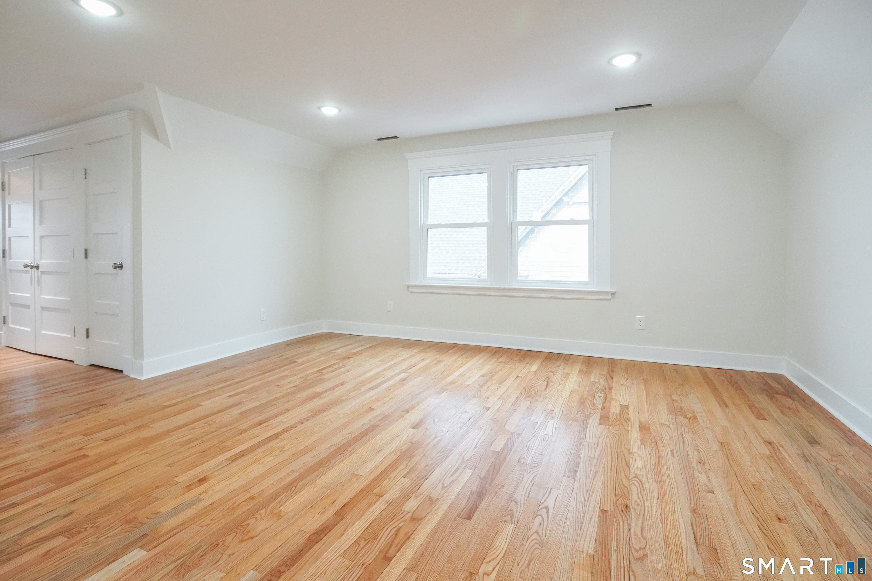 56 Pendleton Street, Unit 3 New Haven, CT 06511 - Photo 11 of 20 an empty room with wooden floor and windows