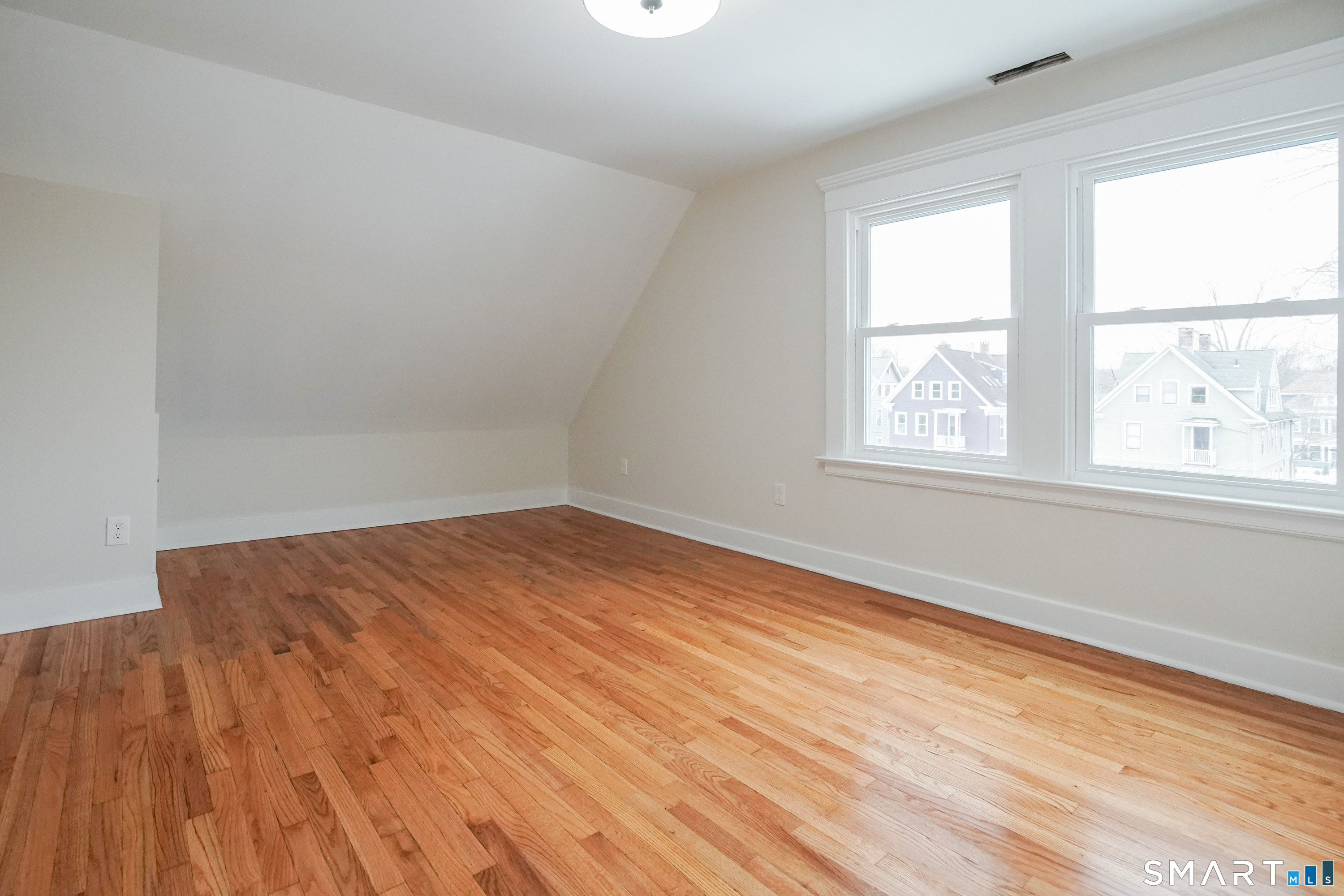 56 Pendleton Street, Unit 3 New Haven, CT 06511 - Photo 16 of 20 an empty room with wooden floor and windows