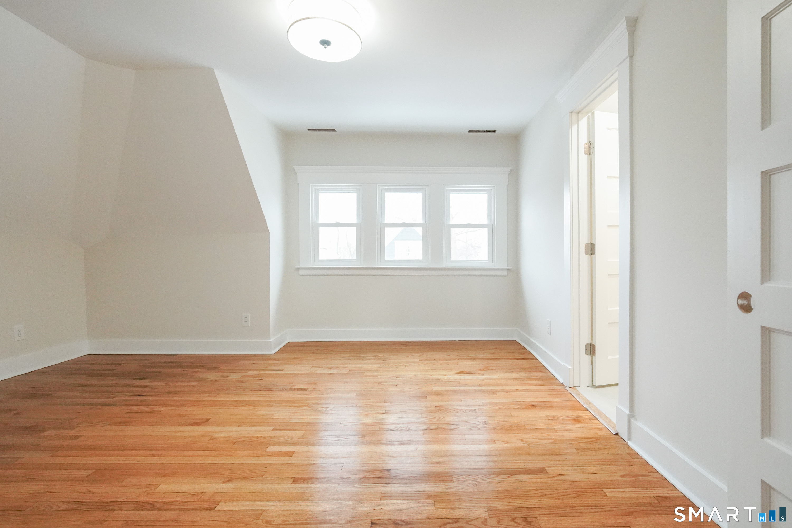 56 Pendleton Street, Unit 3 New Haven, CT 06511 - Photo 7 of 20 wooden floor in an empty room with a window