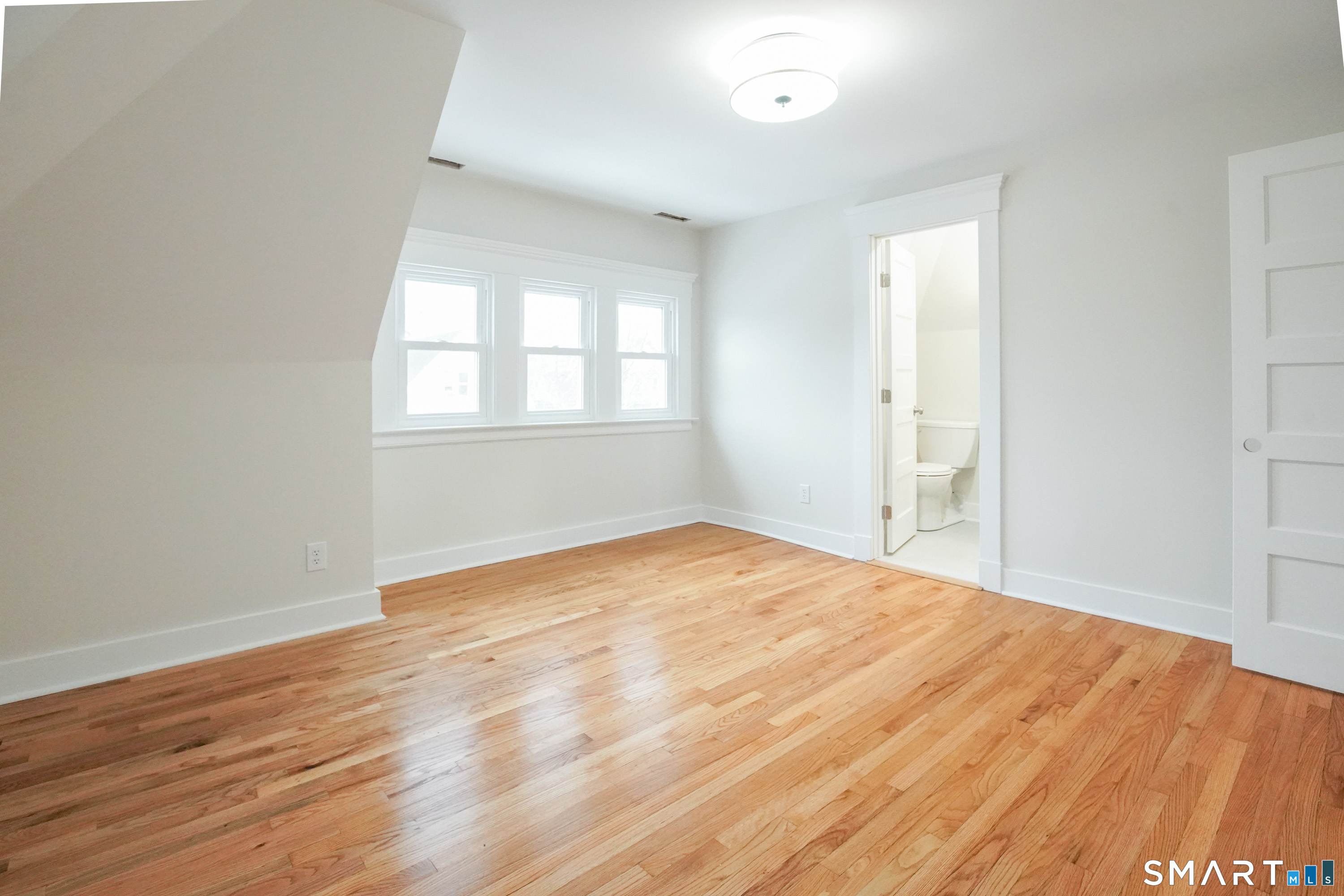 56 Pendleton Street, Unit 3 New Haven, CT 06511 - Photo 8 of 20 an empty room with wooden floor and windows