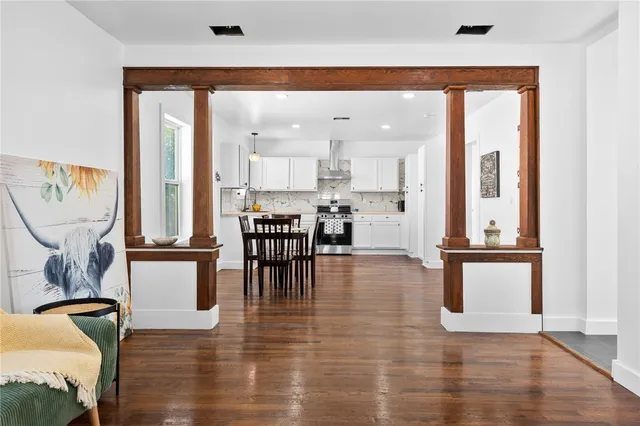 a living room with furniture and kitchen view